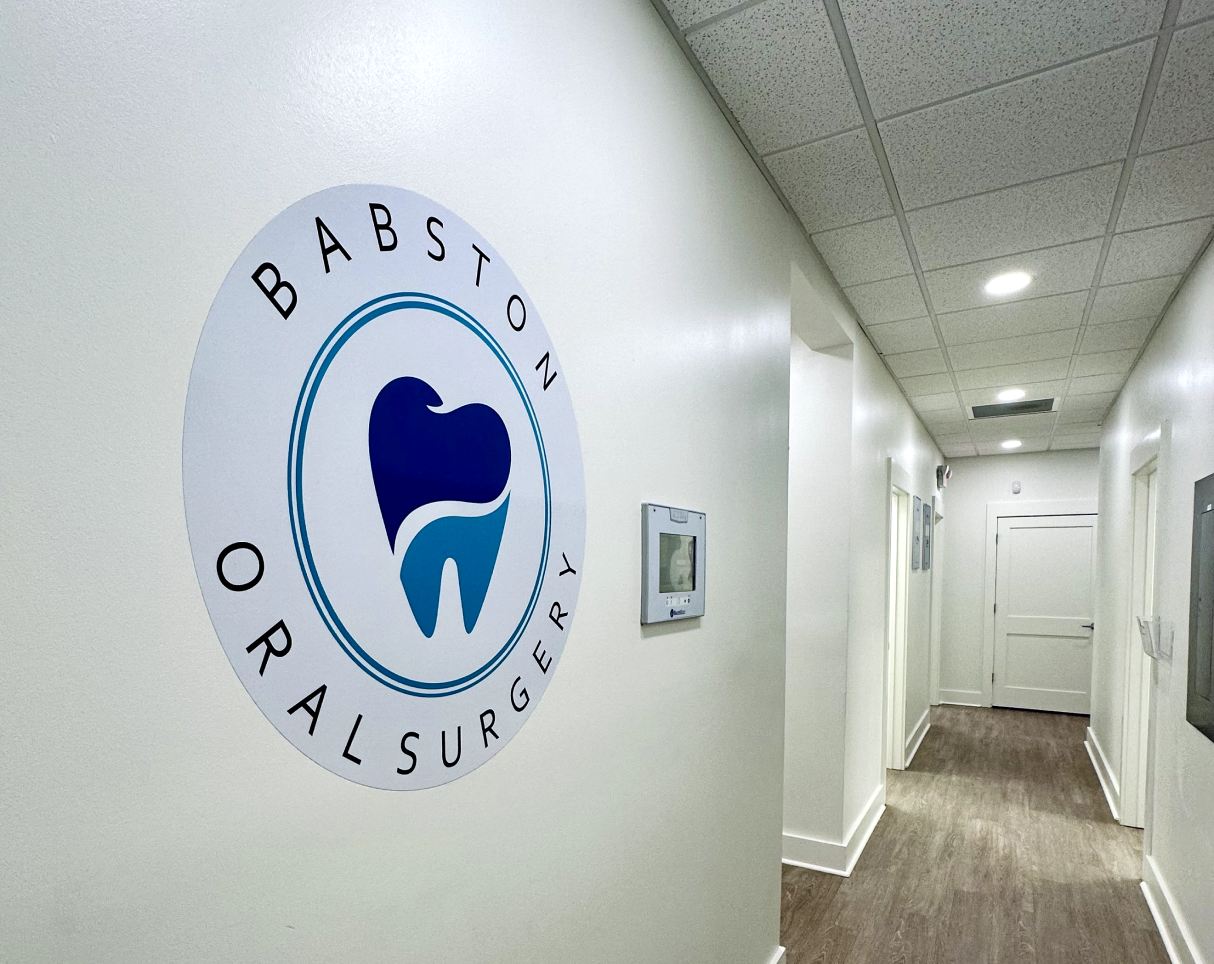 A hallway in the office with the business logo.