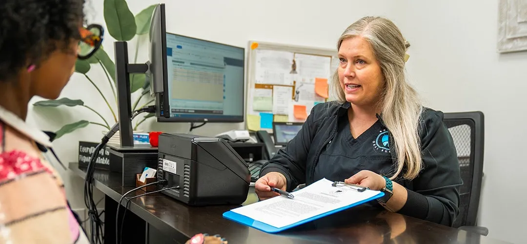 Woman helping with forms at front desk