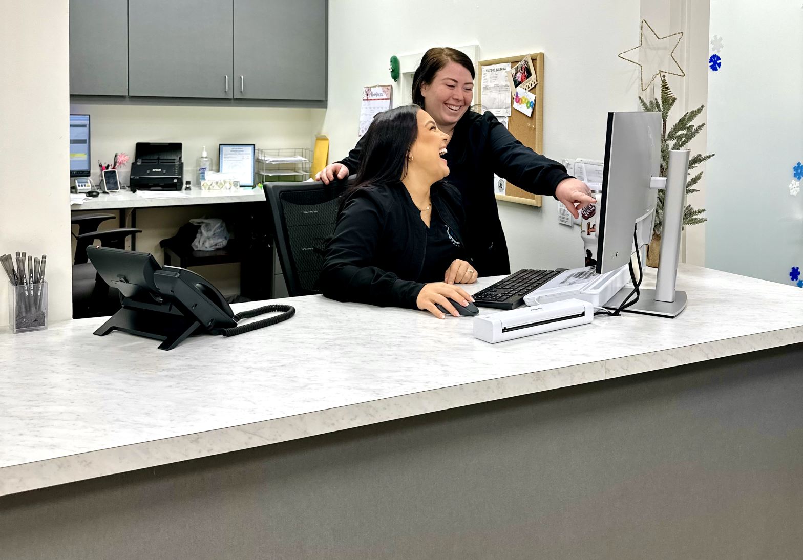 Two team members working at the computer.