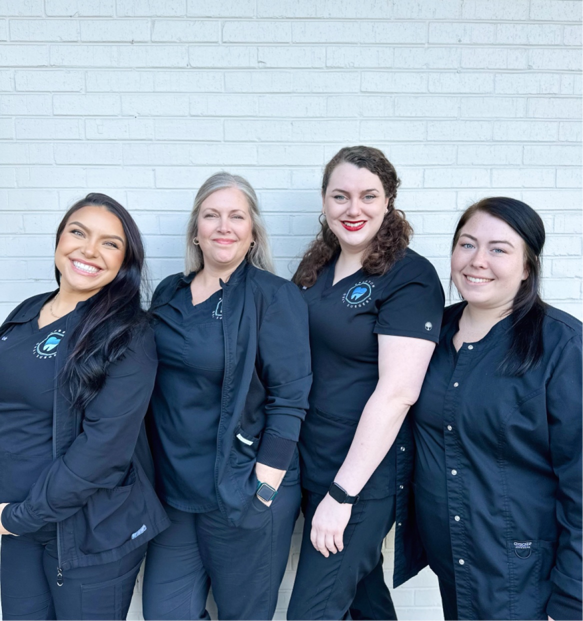 Four team members posing for a group photo.