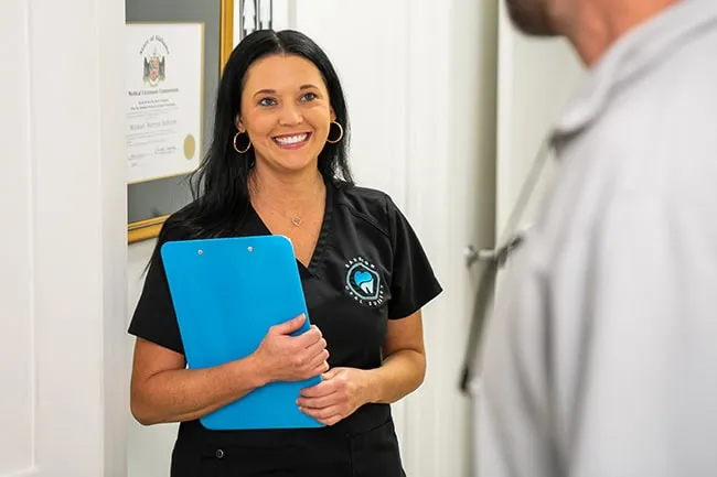 Woman with clipboard smiling