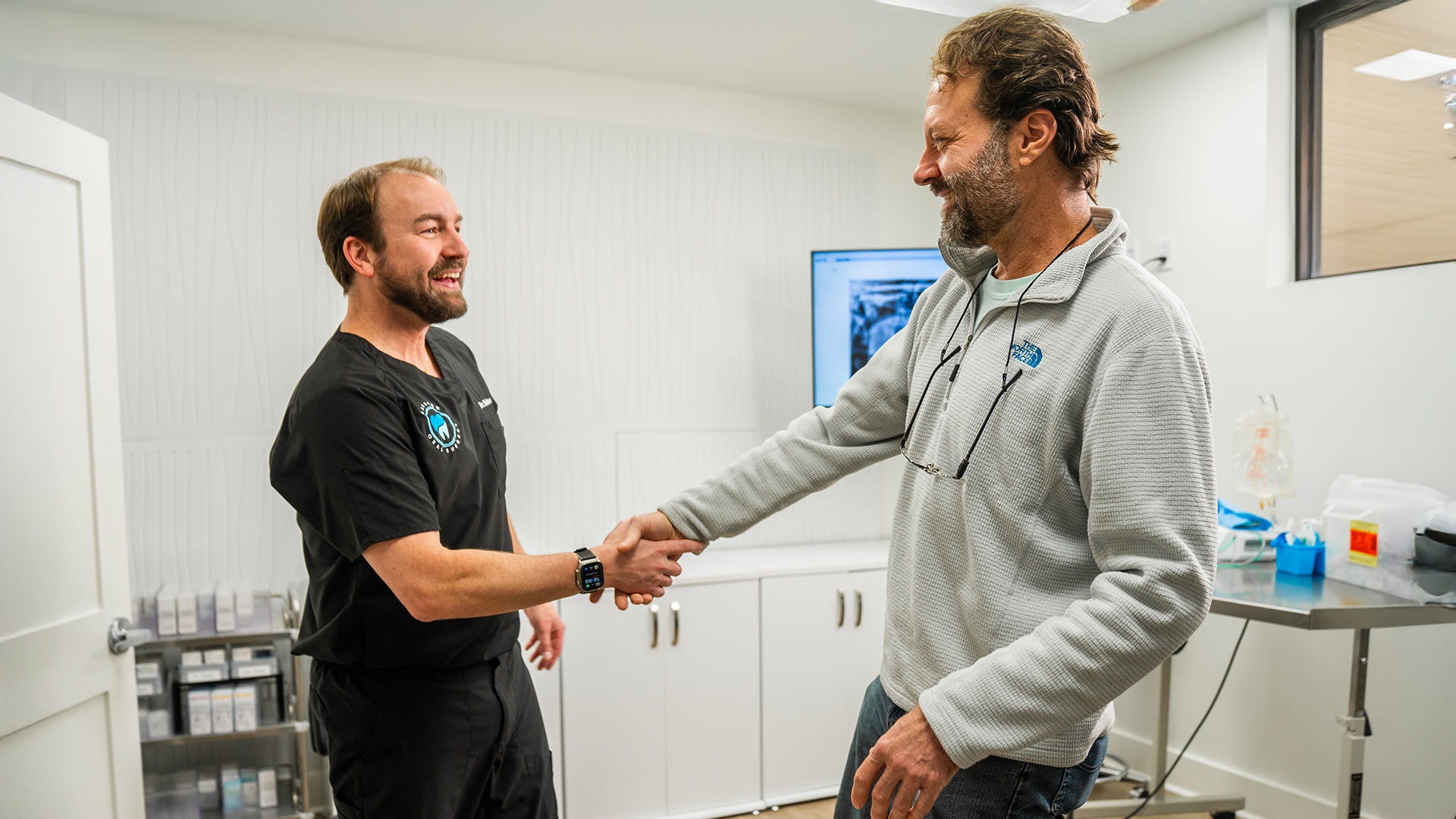 Dr. Babston shaking hands with a patient