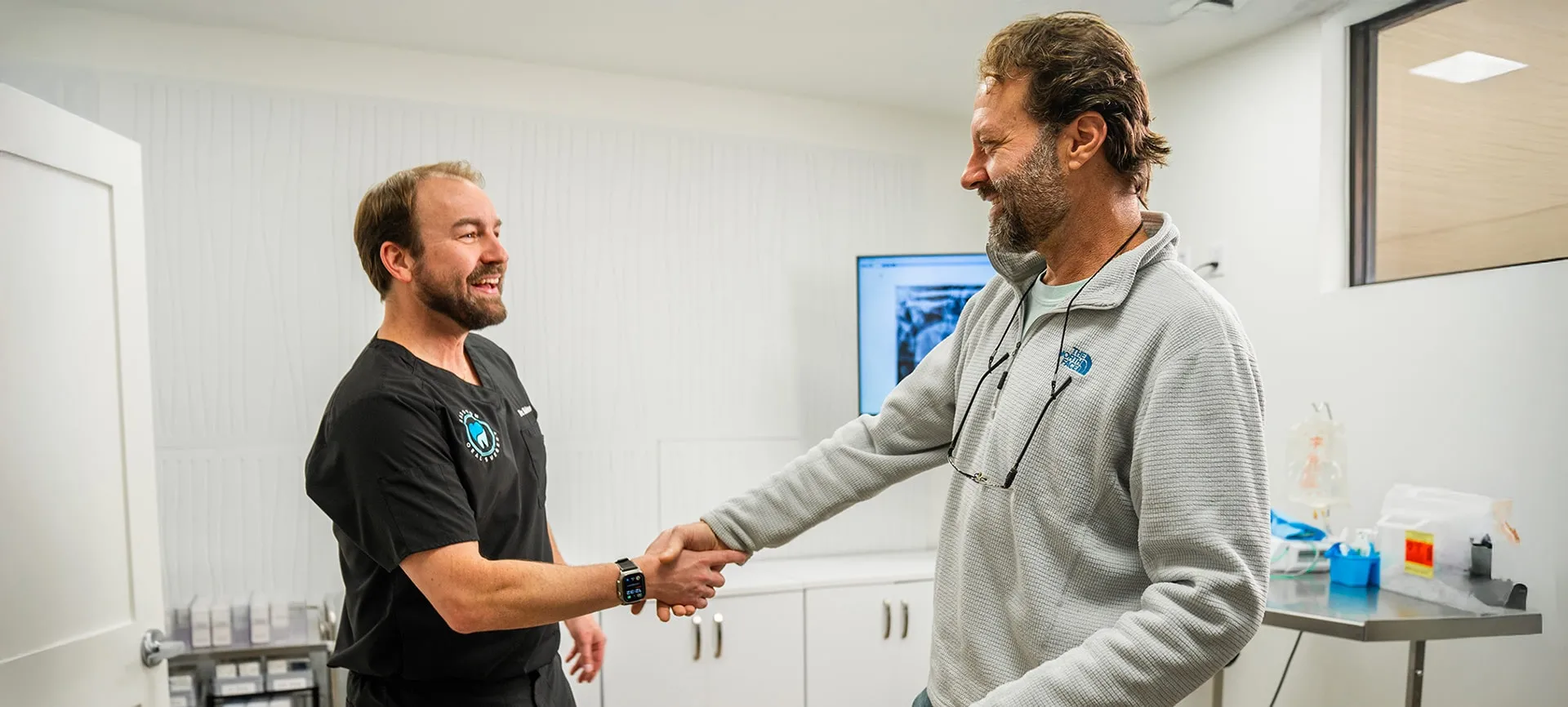 Dr. Babston shaking hands with a patient